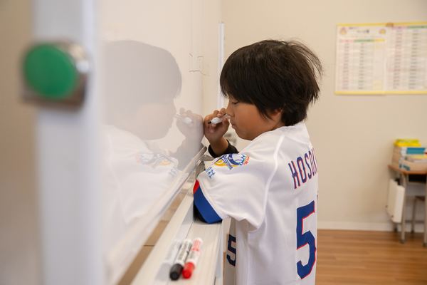 ホワイトボードに向かう子ども